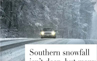  ??  ?? A vehicle makes its way through falling snow Friday near Springvill­e, Ala. Heavy snow fell across several Southern states Friday.