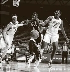  ?? Rod Aydelotte / Associated Press ?? Baylor guard Jordan Turner (5) and teammate Jonathan Tchamwa Tchatchoua (23) fight with Arkansas-Pine Bluff forward Markedric Bell (3) for a rebound.