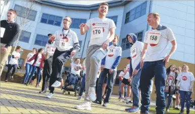  ?? Pictures: Chris Davey FM4260753 ?? Students warm up before the start of the Sports Relief Mile at Canterbury College on Thursday