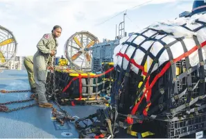  ?? (Ryan Seelbach/U.S. Navy via AP) ?? In this image released by the U.S. Navy, sailors assigned to Assault Craft Unit 4 prepare material recovered Friday off the coast of Myrtle Beach, S.C., in the Atlantic Ocean from the shooting down of a Chinese high-altitude balloon, for transport to the FBI, at Joint Expedition­ary Base Little Creek in Virginia Beach, Va.