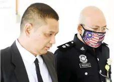  ?? Bernama photo — ?? Mohd Nor Marzukee (right) present in court with Muhamad Iskandar.