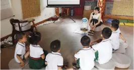  ?? — AFP ?? Educator Candy Xiong introduces a Keeko robot to children at the Yiswind Institute of Multicultu­ral Education in Beijing in July 30.