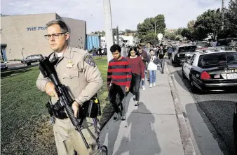  ?? The Associated Press ?? Students are escorted out of Saugus High School after reports of a shooting on Thursday in Santa Clarita, Calif. Two students were killed and three were injured in the early morning shooting.