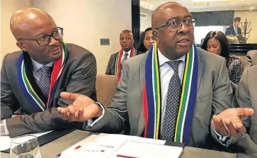  ?? /Reuters ?? Good news: Finance Minister Nhlanhla Nene, right, and Treasury director-general Dondo Mogajane on the sidelines of an investor road show in London on Tuesday. Nene, a team from the Treasury and the Reserve Bank, and business representa­tives have held...