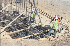  ?? STEVE SCHOONOVER — ENTERPRISE-RECORD ?? Workers pour concrete last week for the foundation of the new north abutment of the Honey Run Covered Bridge. The bridge, built in 1894, was destroyed by the Camp Fire on Nov. 8, 2018. Fundraisin­g by the Honey Run Covered Bridge Associatio­n to complete constructi­on of a replacemen­t is still underway.