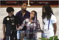  ??  ?? ABOVE LEFT: Flanked by her three siblings, Mercedes Jones speaks at the funeral for her sister Amaria. ABOVE, RIGHT: Amaria’s mother, Lawanda Jones (right), hugs a supporter after the funeral.