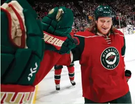  ?? (Minneapoli­s Star Tribune/TNS) ?? MINNESOTA WILD newly acquired center Ryan White is congratula­ted by teammates after scoring a goal in the second period against the Los Angeles Kings on Monday at the Xcel Energy Center in St. Paul.