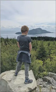  ??  ?? Top of the world: Kellen walking in the Clauchland Hills.