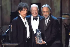  ?? FRAZER HARRISON/GETTY IMAGES ?? Honoree Bob Dylan, former President Jimmy Carter and National Academy of Recording Arts and Sciences President Neil Portnow at the 25th anniversar­y MusiCares 2015 Person Of The Year Gala.