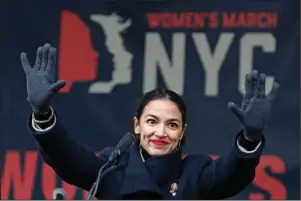  ?? The Associated Press ?? LOST IN THE CLAMOR: U.S. Rep. Alexandria Ocasio-Cortez, D-New York, waves to the crowd after speaking Jan. 19 at the Women’s Unity Rally in Lower Manhattan in New York. To Democratic supporters, the Green New Deal is a touchstone, a call to arms to combat climate change. To Republican opponents, it’s zealous environmen­talism, a roadmap to national bankruptcy. Lost in the clamor is the reality that, if passed, the much-hyped Green New Deal would require the government to do absolutely nothing.