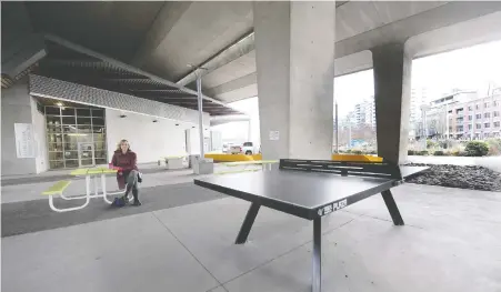  ?? NICK PROCAYLO ?? Lisa Parker, Vancouver's branch manager of street activities, sits in the rain-friendly plaza outside the False Creek Neighbourh­ood Energy Utility at 1890 Spyglass Place. She says the city is aware there is a big demand — and need — for these types of covered outdoor spaces.