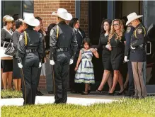  ??  ?? Rosie Diaz holds hands with her 7-year-old daughter, Zivah, after the funeral service for her husband, Omar. A letter Zivah wrote described him as “the best one yet.”