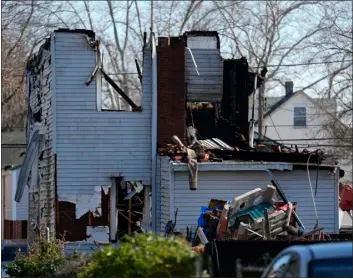  ?? MATT ROURKE — THE ASSOCIATED PRESS ?? Authoritie­s were searching the charred remains of a suburban Philadelph­ia home Thursday morning, a day after a shootout and fire left two police officers wounded and at least six people unaccounte­d for.