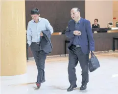  ?? REUTERS ?? Robin Zeng, chairman of Chinese battery giant CATL, walks through the Beijing hotel where Tesla CEO Elon Musk was staying yesterday.