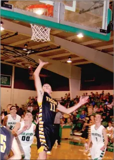  ?? BEN MADRID ENTERPRISE-LEADER ?? Prairie Grove’s Parker Galligan beats Greenland defenders down the middle elevating to the hoop. Galligan scored 7 points in the Tigers’ 40-37 road win on Nov. 24. The Prairie Grove girls lost 51-39 to the Pirates.