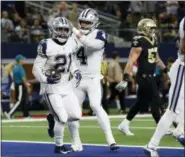  ?? MICHAEL AINSWORTH — THE ASSOCIATED PRESS ?? Dallas Cowboys running back Ezekiel Elliott (21) celebrates his touchdown against the New Orleans Saints with quarterbac­k Dak Prescott (4) in the first half of an NFL football game, in Arlington, Texas, Thursday.