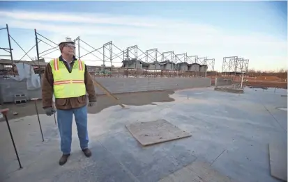  ?? NIKKI BOERTMAN/THE COMMERCIAL APPEAL ?? Superinten­dent John Aitken in the future library and media center at the new Colliervil­le High School, scheduled to open in 2018.