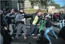  ?? Oded Balilty / AP Photo ?? A hardline nationalis­t supporter of Israeli solider Elor Azaria is detained by police outside the military court in Tel Aviv.