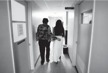  ?? REBECCA BLACKWELL/AP ?? Clinic administra­tor Kathaleen Pittman escorts a mother of three from Texas down the hall before an abortion Saturday at Hope Medical Group for Women in Shreveport, La. Texas has the nation’s most restrictiv­e abortion law.