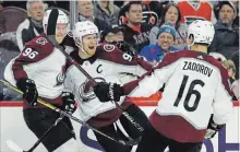  ?? ASSOCIATED PRESS FILE PHOTO ?? In the off-season, Colorado Avalanche captain Gabriel Landeskog, centre, pushed around a heavy sled in workouts to get more explosive on the ice. He has 10 goals and six assists to start the season.