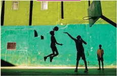  ??  ?? JEREMY LASKY, NATIONAL GEOGRAPHIC YOUR SHOT Young boys play basketball after school in Havana, Cuba. While not quite as popular as baseball, basketball has a long history in this country.