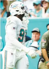  ?? WILFREDO LEE/AP ?? Dolphins defensive end Emmanuel Ogbah is escorted off the field after he was injured during a game against the Browns on Nov. 13 in Miami Gardens.