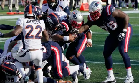  ?? AP Photo/Steven Senne ?? New England Patriots quarterbac­k Cam Newton (center) bulls his way to the goal line and a touchdown in the second half of an NFL football game against the Denver Broncos, on Sunday in Foxborough, Mass.