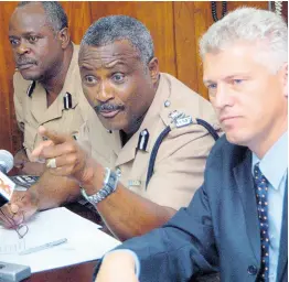  ?? FILE ?? In this October 2005 photograph, then Police Commission­er Lucius Thomas addresses journalist­s during a press conference at his Old Hope Road, St Andrew, offices. He is flanked by Mark Shields (right), then deputy commission­er, and Linval Bailey, then acting deputy commission­er.
