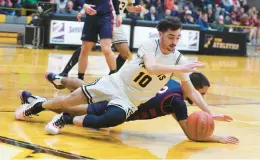  ?? AMY SHORTELL/THE MORNING CALL ?? Freedom’s Joseph Dew scrambles for the ball with Liberty’s Nate Rivera. With 41 seconds left, Dew hit the go-ahead 3-pointer as the Patriots rallied from a 12-point deficit in the fourth quarter to beat Liberty 54-49.