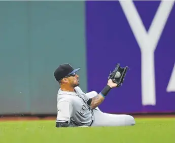  ??  ?? Rockies left fielder Ian Desmond makes a sliding catch, taking a hit away from the Giants’ Joe Panik during the first inning Tuesday night at AT&T Park. Thearon W. Henderson, Getty Images