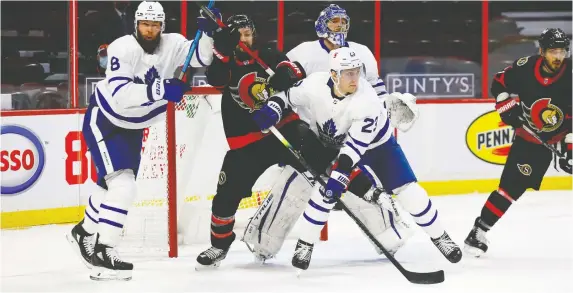  ?? ERROL MCGIHON ?? Ottawa's Derek Stepan battles with Maple Leafs' Jake Muzzin, left, and Travis Dermott in front of Toronto goalie Frederik Andersen Friday night at the Canadian Tire Centre.