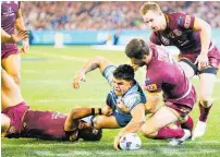  ?? Photo / Getty Images ?? Blues centre Latrell Mitchell scores for NSW last night.