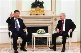  ?? SERGEI KARPUKHIN / SPUTNIK, KREMLIN POOL PHOTO VIA AP ?? Chinese President Xi Jinping gestures while speaking to Russian President Vladimir Putin during their meeting at the Kremlin in Moscow, Russia, Monday.