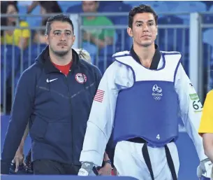  ?? ROBERT HANASHIRO, USA TODAY SPORTS ?? Jean Lopez, left, coached his brother, Steven, a two-time Olympic taekwondo gold medalist, at the Rio Games last year. Both are accused of sexually assaulting women.