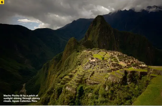  ?? ?? Machu Picchu lit by a patch of sunlight shining through stormy clouds, Aguas Calientes, Peru.