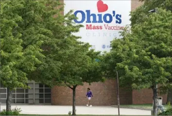  ?? Tony Dejak/Associated Press ?? A man walks to the entrance for Ohio’s COVID-19 mass vaccinatio­n clinic May 25 at Cleveland State University in Cleveland. Vaccinatio­n incentives across the U.S., such as Ohio’s Vax-a-Million, aren’t working as well as health officials want them to as vaccinatio­n rates drop off and a highly contagious and potential more severe virus variant increases its presence.