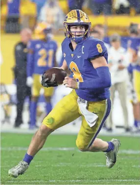  ?? CHARLES LECLAIRE/USA TODAY SPORTS ?? Pittsburgh quarterbac­k Kenny Pickett runs for a first down against North Carolina on Nov. 11. Pittsburgh won 30-23 in overtime.