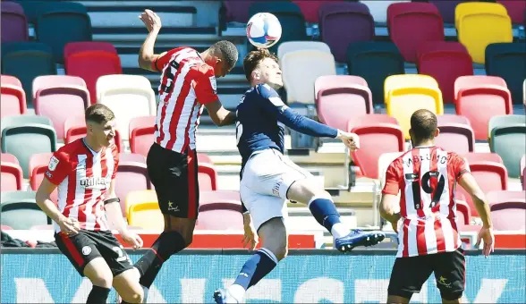  ?? PICTURE: Alamy ?? HIGH RISE: Brentford defender Ethan Pinnock contests a header with Millwall’s Jake Cooper