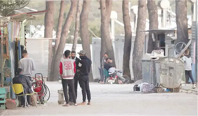  ?? Reuters ?? ↑
Migrants are seen at the Ritsona camp during a lockdown in Ritsona, recently.