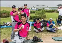  ?? ?? Ryuzaki, foreground, with the Ryuyukai softball team.