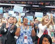  ??  ?? New York delegates cheer Tuesday as they hold up signs during the second-day session of the Democratic National Convention in Philadelph­ia.