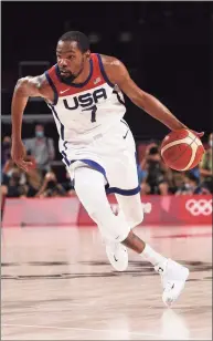  ?? Kevin C. Cox / Getty Images ?? The United States’ Kevin Durant drives to the basket against France during the first half of the gold-medal game at the Olympics on Saturday.