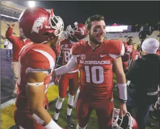  ??  ?? DUELING QUARTERBAC­KS: Arkansas defensive back Jared Collins celebrates with quarterbac­k Brandon Allen after beating No. 9 LSU 31-14 last week at Tiger Stadium in Baton Rouge, La. Allen faces off against all-Southeaste­rn Conference quarterbac­k Dak...