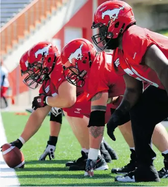  ?? Gavin Young/Calgary Herald ?? The Calgary Stampeders offensive line sets up during practice at McMahon Stadium on Tuesday. They know they have their work cut out with the sack-happy Eskimos coming to town.