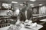  ??  ?? CEO David McKillips shows off menu items at the Sugar Land Chuck E. Cheese location Tuesday.