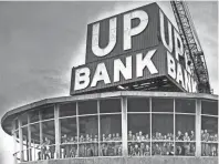  ?? COMMERCIAL APPEAL THE ?? The Union Planters National Bank sign atop the 100 North Main Building glowed for the first time on May 11, 1965. On hand for the occasion were 51 representa­tives of Boy Scout Troop 97 of Whitehaven, who became the first group to hold a meeting in the still-unfinished Top of the 100 Club penthouse revolving restaurant.