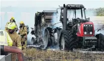 ?? PHOTO: RICHARD DAVISON ?? Down and out . . . Firefighte­rs stand by after extinguish­ing a tractor and stubble fire in a Waiwera South paddock yesterday.
