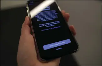  ?? JENNY KANE — THE ASSOCIATED PRESS ?? A screen displays a notice when installing the update, iOS 13.2on an iPhone on Tuesday in New York. Apple is resuming the use of humans to review Siri commands and dictation with the latest iPhone software update.