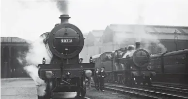  ??  ?? No 1071 was one of the LMS Fowler Compounds built at Derby Works and was released to traffic in September 1924. The LMS Compounds were a post-grouping developmen­t of the Midland design with 6ft 9in coupled wheels, reduced boiler mountings and a nominal tractive effort of 22,650lbs, an increase over the 21,840lbs of the Midland engines with their 7ft coupled wheels. Alongside in the carriage sidings is one of the Fowler ‘483’ class renewals of the Johnson ‘slim boilered’ 4-4-0s that became known as the ‘2P’ class. Returning to No 1071, apart from the running number, the reduced height of the chimney and dome covers of the LMS Compounds was the easiest way of quickly identifyin­g a Midland-built Compound from it LMS cousin.