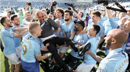  ?? | EPA ?? MANCHESTER City manager Pep Guardiola was celebrated by his players after their last English Premier League match against Brighton and Hove Albion on Sunday. Manchester City won 4-1 to successful­ly defend the Premier League title.